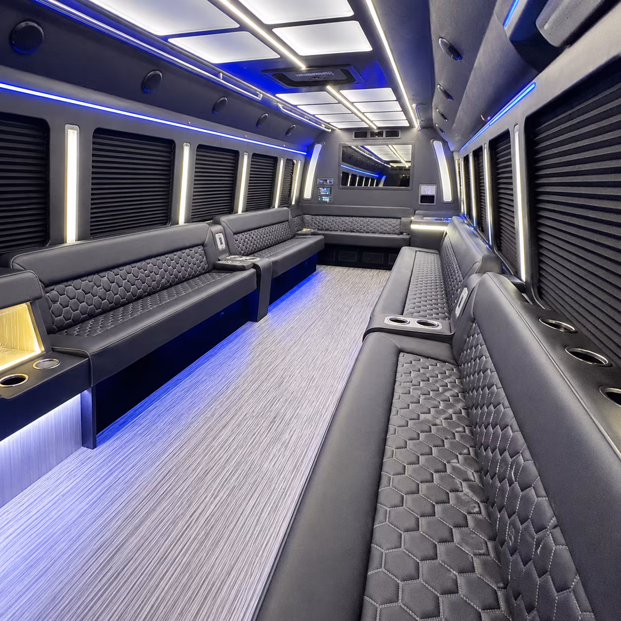 Wedding guests seated inside a party bus serving Queens